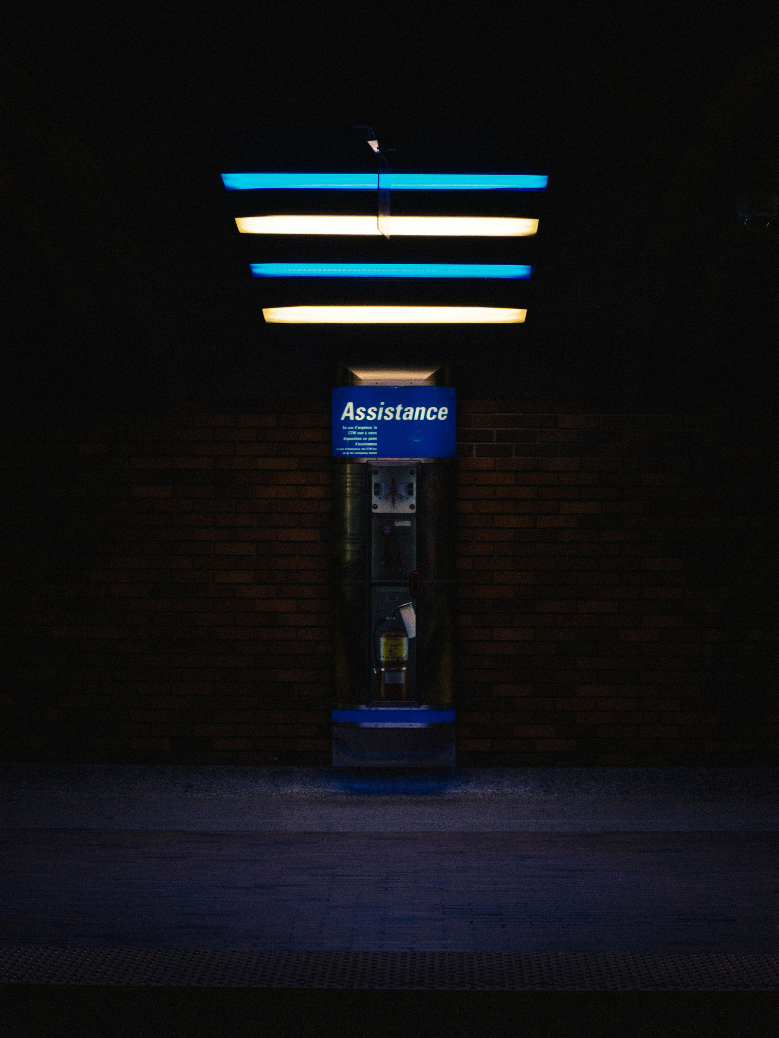 cabine téléphonique d'assistance dans la nuit illuminée par des néons